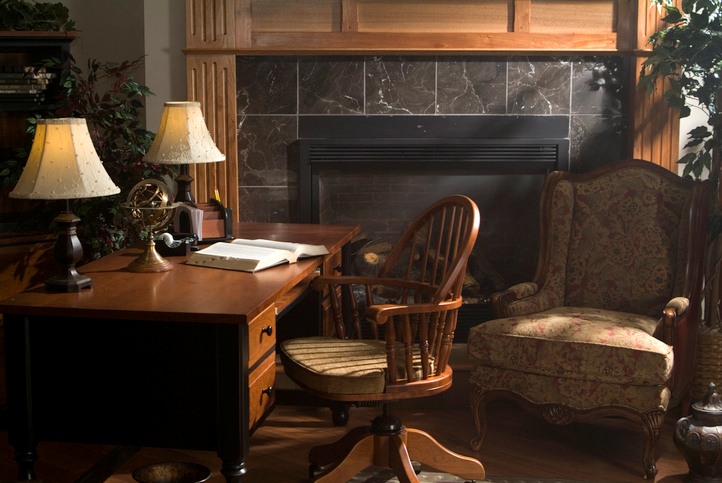 Classic wooden desk and armchair by a fireplace in Central Ohio